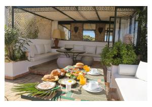 a table with food on it in a patio at La Maison de Tanger in Tangier