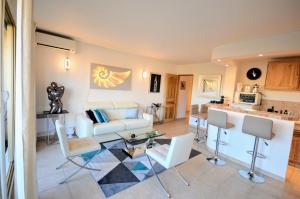a living room with a couch and a table at Saint Tropez Sea View Penthouse in Saint-Tropez