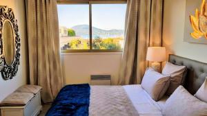 a bedroom with a bed and a large window at Saint Tropez Sea View Penthouse in Saint-Tropez +43 photos
