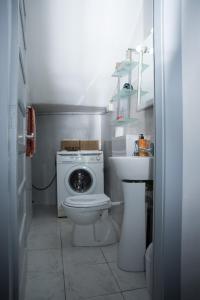 a small bathroom with a toilet and a sink at Green House in Villaputzu