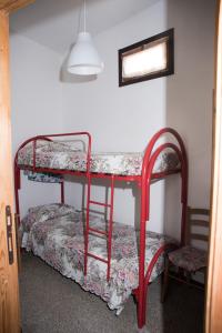 a bedroom with two bunk beds and a chair at Green House in Villaputzu