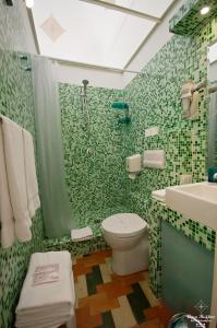 a bathroom with a toilet and a shower and a sink at B&B Casa Ruffino in Balestrate