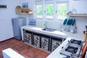 a kitchen with a sink and a stove in it at Serendib House in Unawatuna +28 photos