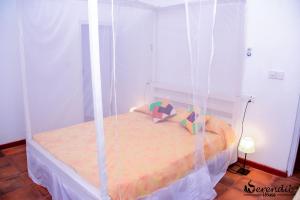 a bedroom with a bed with a canopy at Serendib House in Unawatuna