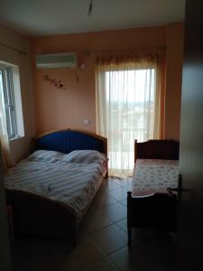 a bedroom with a bed and a window at Dimitri's house in Dhílesi