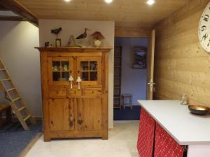a kitchen with a wooden cabinet and a counter at Gite l'Ancolie in Marignier