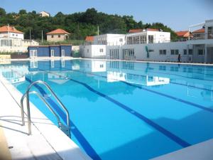 a large swimming pool with blue water at Apartment Lavanda in Sinj