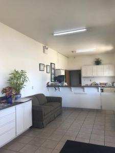 a living room with a couch and a kitchen at Heights Inn in Harker Heights