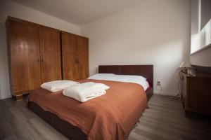 a bedroom with a bed with two towels on it at RiverView apartment in Osijek
