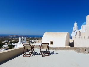two chairs sitting on the roof of a building at Pantelia Pyrgos in Pyrgos