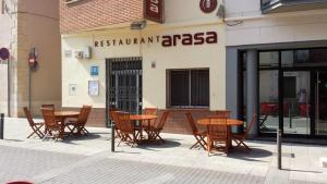 a group of tables and chairs outside of a restaurant at Hostal Restaurante Arasa in Santa Bárbara