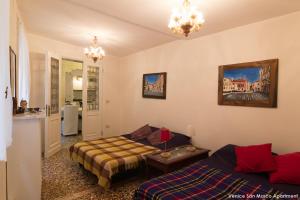 a living room with a couch and a bed at Venice San Marco Apartment in Venice