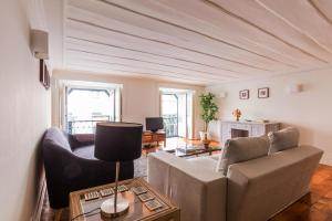 a living room with a couch and a table at Rua Sao Bento Apartment in Lisbon