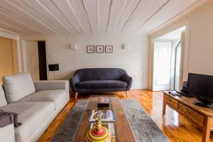 a living room with a couch and a table at Rua Sao Bento Apartment in Lisbon