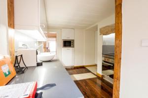 a kitchen with a sink and a tub in a room at Rua Sao Bento Apartment in Lisbon