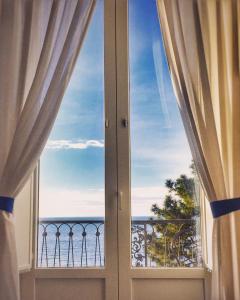 an open window with a view of the ocean at L'Ancora Amalfi Dreams in Minori