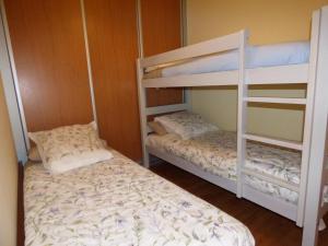 two bunk beds in a room with a bed at Nature Appartements Font Romeu in Font-Romeu +29 photos
