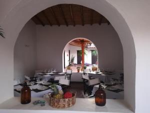 a dining room with tables and chairs and an archway at Hotel Casa Claustro De Zapatoca in Zapatoca