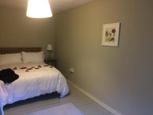 a bedroom with a bed and a picture on the wall at The Groom's Cottage in Navan