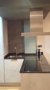 a kitchen with a sink and a counter top at APARTAMENTO HERREROS 28 in Pontevedra