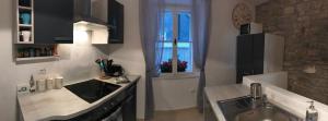 a kitchen with a sink and a window at Charming House in the Center of Piran in Piran +37 photos
