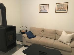 a living room with a couch and a stove at Charming House in the Center of Piran in Piran