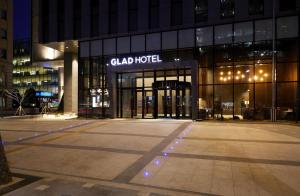 a glass building with a sign on it at night at GLAD Gangnam COEX Center in Seoul