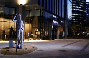 a statue of a woman standing in front of a building at GLAD Gangnam COEX Center in Seoul