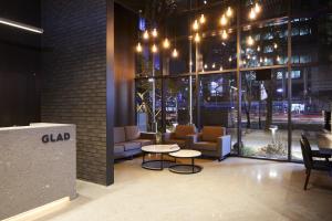 a lobby with chairs and a table in a building at GLAD Gangnam COEX Center in Seoul