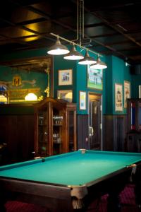 a billiard table in a room with a green table at O'Hara in Voronezh