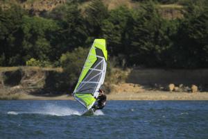 a man is windsurfing on a body of water at Arenaguas Beach House in Matanzas