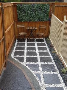 a patio with a table and chairs in front of a fence at Edwin Place Apartment in Glenwood