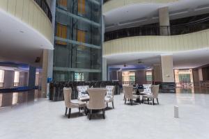 a restaurant with chairs and tables in a building at 钻石名邸 Diamond One Hotel and Serviced Apartment in Phnom Penh