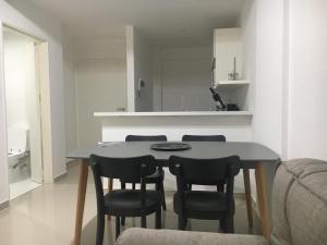 a dining room table and chairs in a room at Departamento en Palermo Soho in Buenos Aires