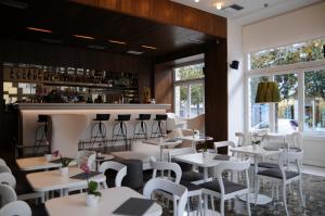 a restaurant with white tables and white chairs at Hotel Metropolis in Ioannina