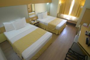 Postel nebo postele na pokoji v ubytování Microtel by Wyndham Davao
