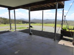 a patio with a view of a field and mountains at Yuruga in Preston