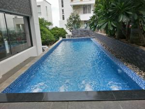 a swimming pool in the middle of a house at Nancy Villa in Vung Tau