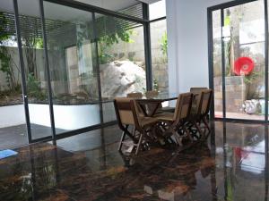 a dining room with a table and some chairs at Nancy Villa in Vung Tau