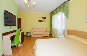 a living room filled with furniture and a tv at Prichal Hotel in Kaluga
