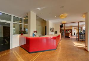 a kitchen with a red counter in the middle of a room at Brackweder Hof in Bielefeld