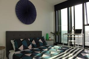 a bedroom with a bed and a large window at Spectacular Views of CBD by FV with Free Car Park in Brisbane