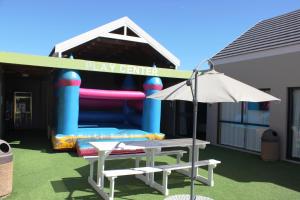 a play center with a table and an umbrella at Break-A-Way in Langebaanweg