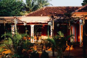a house with a lot of plants in front of it at Allens home stay in Jaffna