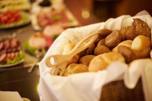 a basket of different types of bread and pastries at Panoramahotel Berghof in Baiersbronn