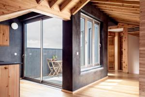 a kitchen with large windows and a dining room with a table at Porto Pim Bay in Horta