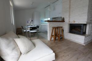 a living room with a white couch and a fireplace at Apartments Marko Rava in Rava
