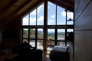 a living room with a large window with a view of a deck at The Grange Lodge in Napier