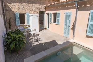 a house with a swimming pool next to a building at Blue Casita ETV 7845 in Pollença