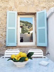 a bowl of lemons on a table with a window at Blue Casita ETV 7845 in Pollença